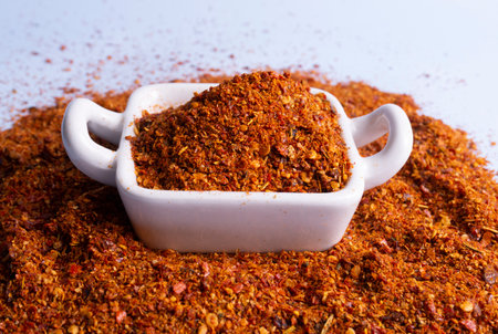 red chili pepper ground in white ceramic container