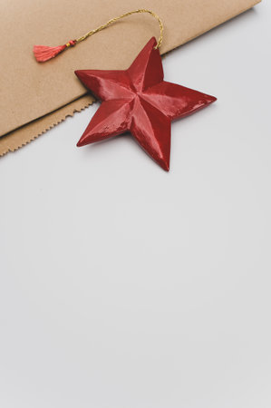 red painted decorative wooden star on a white background with copy spaceの写真素材
