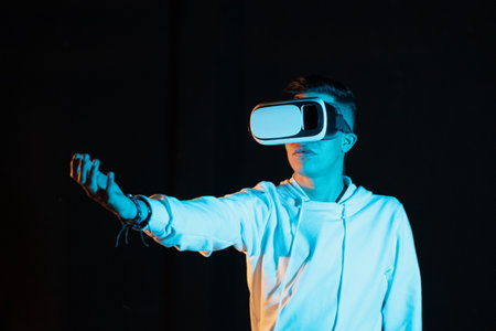 Young man experiencing virtual reality for the first time. Seeing different virtual worlds.