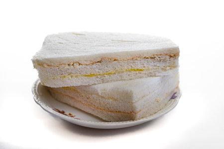 white sliced bread sandwiches on plate and background of the same colorの写真素材