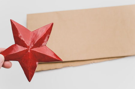 red painted decorative wooden star on a white background with copy spaceの写真素材