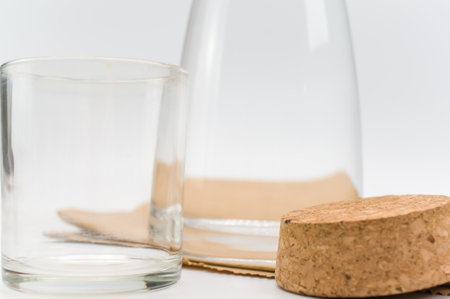 glass flask filled with pure clean water on a white and food paper background with text spaceの写真素材