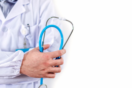 Close-up of male doctor holding stethoscope.の写真素材