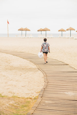 Young woman on a beautiful beach. Enjoying the day tanning.の写真素材
