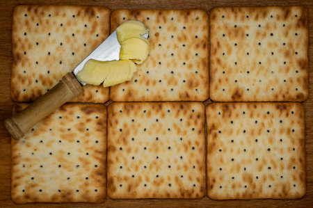 crackers forming a rectangle and knife with butterの写真素材