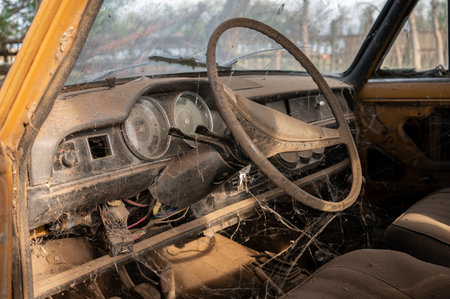 Inside of an abandoned car, dirty and with cobwebsの写真素材