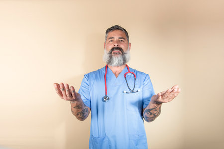 Portrait of doctor smiling and gesturing while standing against wall background.Health workers,...