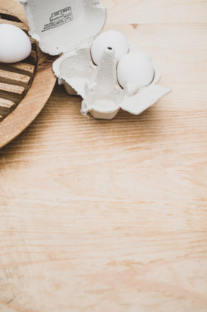 cardboard egg box made of recyclables materials with space for text on a wooden tabletop