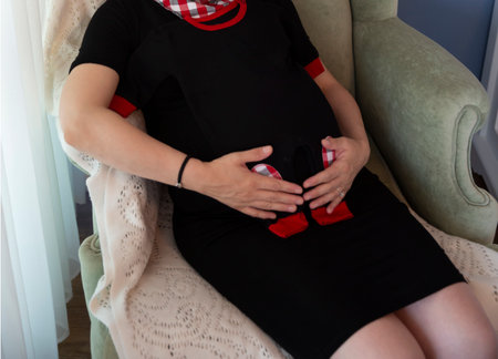 touching her pregnant belly with her handsの写真素材