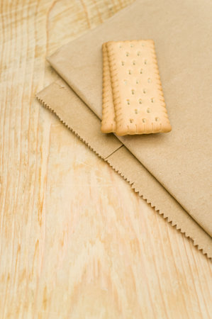 natural bio organic dry crispy biscuits on a Kraft paper and rustic wooden tabletopの写真素材