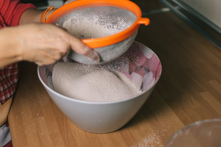 Woman preparing sponge cake. Woman preparing homemade sponge cake at home.の写真素材