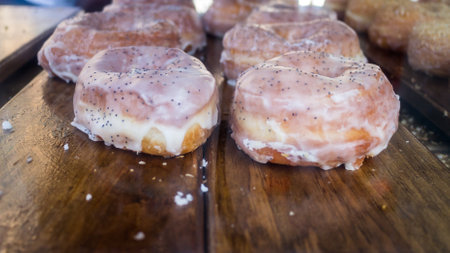 Display of delicious fresh glazed donuts with frosted icingの写真素材