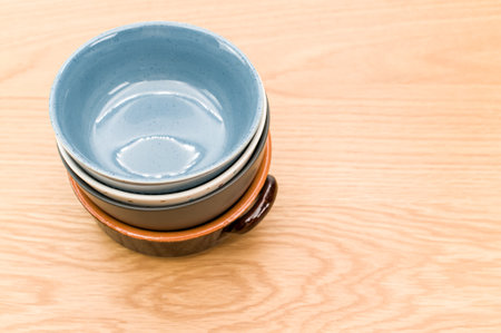 isolated earthenware bowls on a wooden background with copy space