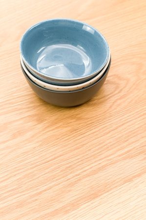 isolated earthenware bowls on a wooden background with copy space