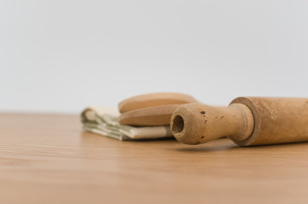 natural wood kitchen utensils and a table napkin on a wooden background with copy spaceの写真素材