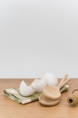 natural wood kitchen utensils and a table napkin on a wooden background with copy space