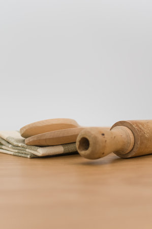 natural wood kitchen utensils and a table napkin on a wooden background with copy spaceの写真素材