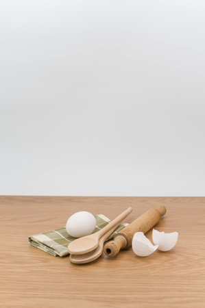 natural wood kitchen utensils and a table napkin on a wooden background with copy spaceの写真素材