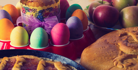 Colorful festive easter eggs and easter sweet bakingの写真素材
