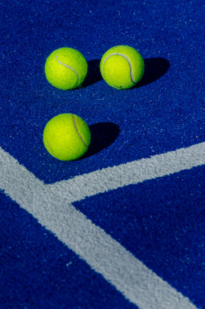 Selective focus three balls next to the lines of a paddle tennis courtの写真素材
