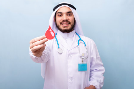 Saudi doctor shows the figure of a drop of blood. Blood donation concept.の写真素材