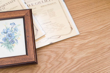 images and posters in glass clip frames on a wooden surface with copy spaceの写真素材