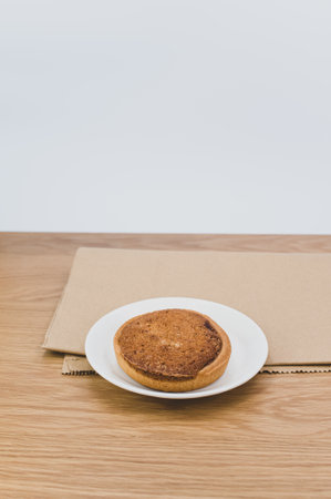 bio organic vegan tart in a white plate on a wooden tabletopの写真素材