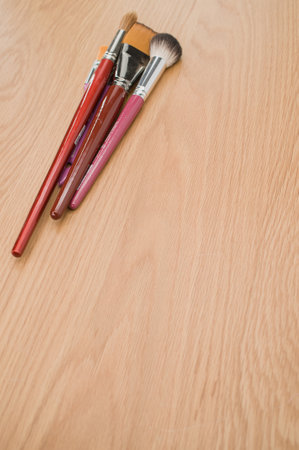 set of paintbrushes on a wooden tabletop with copy spaceの写真素材