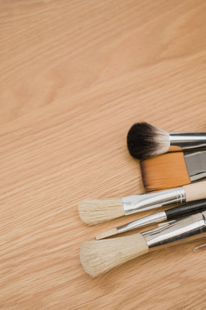 set of paintbrushes on a wooden tabletop with copy spaceの写真素材