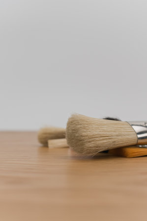 set of paintbrushes on a wooden tabletop with copy spaceの写真素材