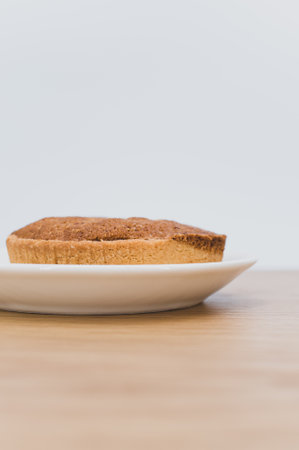 bio organic vegan tart in a white plate on a wooden tabletopの写真素材