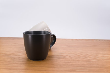 isolated earthenware cups on a wooden background with copy space