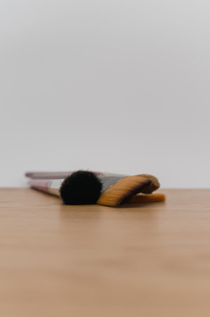 set of paintbrushes on a wooden tabletop with copy space