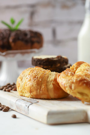 croissant and coffee in a cup breakfast and coffee grainsの写真素材