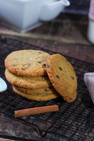 butter cookies on a baking rack with cinnamon tea kettle milk and a blue spoon