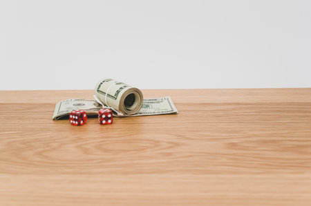 US dollar currency banknotes and dice on a wooden background with copy spaceの写真素材