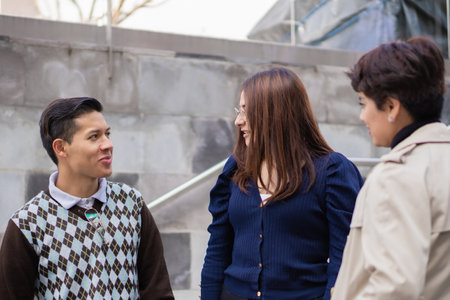 Co-workers leaving the office talking together about different work issues and how to improve their entire business.の写真素材