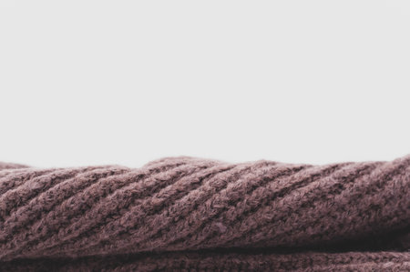 isolated dark brown knitted cloth on a white tabletop with text spaceの写真素材