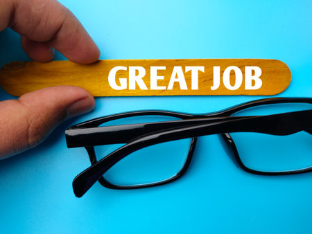 Glasses and colored ice cream stick written with text GREAT JOB on blue background.の写真素材