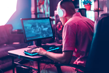 back man of gamer man playing on a computer.の写真素材
