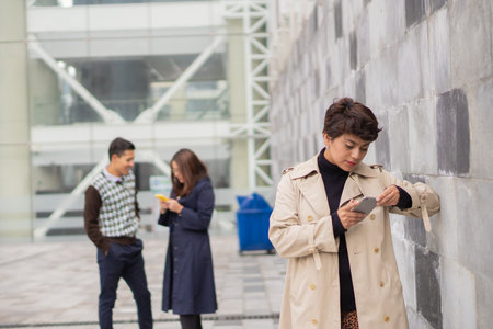 Young woman with her coworkers in the foreground. Analyzing all the data of your work and productivity.の写真素材