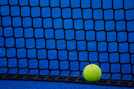 paddle tennis court, a ball by the netの写真素材