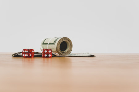 US dollar currency banknotes and dice on a wooden background with copy spaceの写真素材