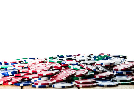 Poker chips over wooden table and white background. Casino concept for business, risk, chance, good luck or gamblingの写真素材
