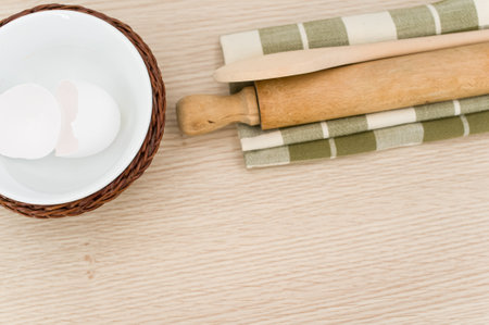 natural wood kitchen utensils and a table napkin on a wooden background with copy spaceの写真素材