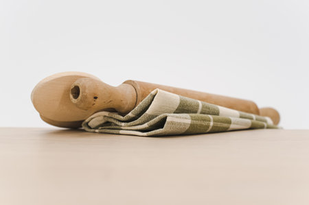 natural wood kitchen utensils and a table napkin on a wooden background with copy spaceの写真素材
