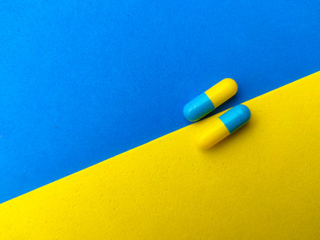 Piles of pills and capsules with copy space on colorful background.Selective focus.