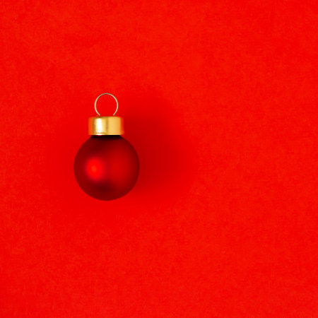 Red ball Christmas decoration on a red backgroundの写真素材