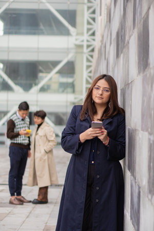 Young woman with her coworkers in the foreground. Analyzing all the data of your work and productivity.の写真素材