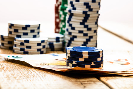 Poker casino chips and money close up. Casino concept, risk, chance, good luck or gambling. Detail of casino chips, EURO, US dollarsの写真素材